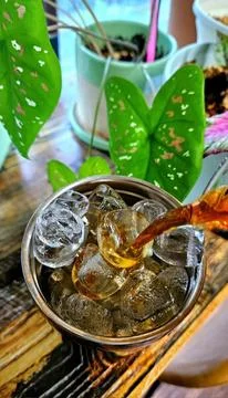 Refreshing iced tea served in a chilled glass, featuring a deep amber hue a.. Stock Photos