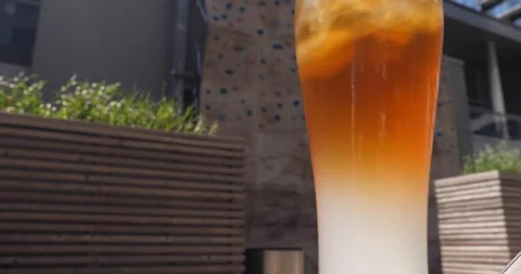 Refreshing Jasmine Palmer Iced Tea in a BBQ terrace in a warm windy afternoon Stock Footage 100039429