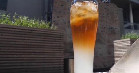 Refreshing Jasmine Palmer Iced Tea in a BBQ terrace in a warm windy afternoon Stock Footage 100039430