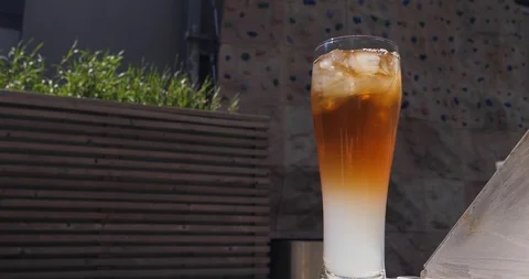 Refreshing Jasmine Palmer Iced Tea in a BBQ terrace in a warm windy afternoon Stock Footage 100039432