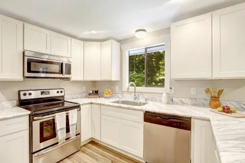 Refreshing kitchen interior with white cabinets. Stock Photos
