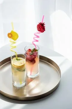 Refreshing lemon and strawberry summer drinks on tray Stock Photos
