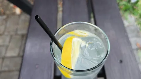 Refreshing Lemon Infused Water with Ice Stock Footage 344913981