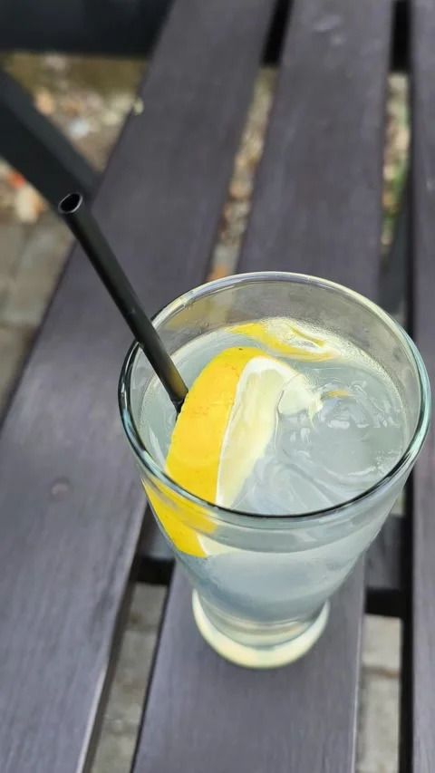 Refreshing Lemon Infused Water with Ice Stock Footage 344913983
