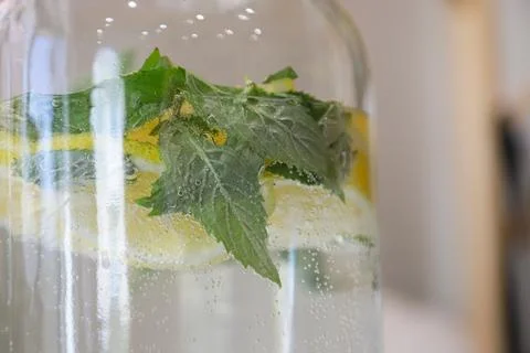 Refreshing lemon mint beverage in a clear glass jar with bubbles captured i.. Stock Photos