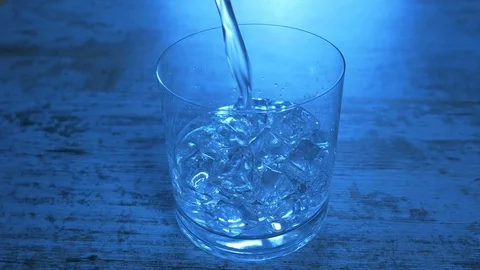 Refreshing Lemon Soda in a Glass. Close-up of lemon water on blue background. Stock Footage 117624432