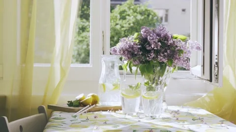 Refreshing lemon water on kitchen table 스톡 동영상 195211893