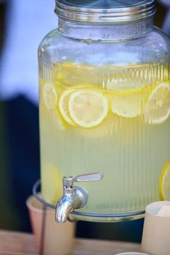 Refreshing lemonade dispenser serving cold summer drink Stock Photos