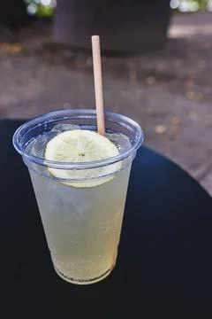 Refreshing lemonade with eco friendly straw on table Foto stock