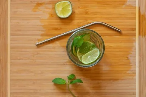 Refreshing lemonade with mint, lime and ice in a glass jar with a metal straw Stock Photos