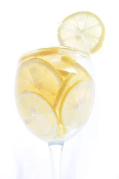 Refreshing lemonade or limoncello cold drink. Sliced fresh ripe lemons rings Stock Photos