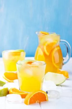 Refreshing lemonade with oranges and apple Stock Photos