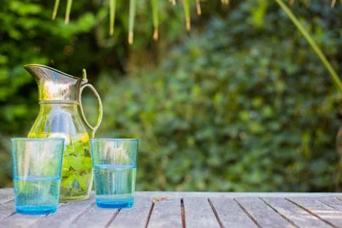 Refreshing lemonade with oranges and mint on wooden table. on a summer day with Stock Photos