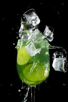 Refreshing Lime Splash with Ice Cubes Stock Photos
