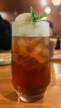 Refreshing Lychee Iced Tea with Mint Garnish and Foam in Tall Glass Stock Photos