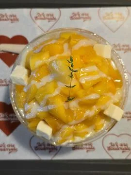 Refreshing mango bingsu with fluffy shaved ice, sweet mango chunks, and cre.. Stock Photos