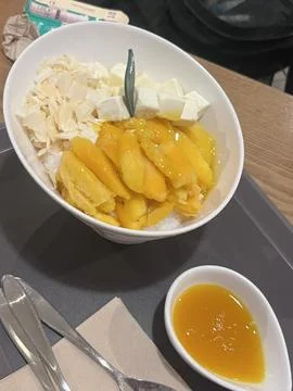Refreshing mango bingsu with fluffy shaved ice, sweet mango chunks, and cre.. Stock Photos
