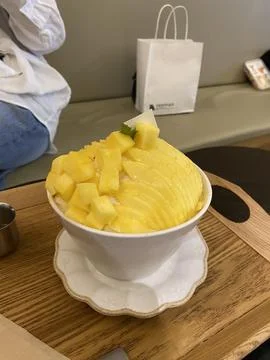 Refreshing mango bingsu with fluffy shaved ice, sweet mango chunks, and cre.. Stock Photos