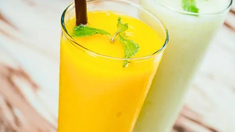 Refreshing mango smoothie with mint garnish Stock Photos