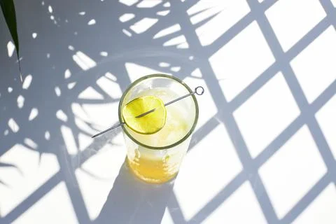 Refreshing melon smoothie with ice and lime in the sun. Summer cooling drinks. Stock Photos