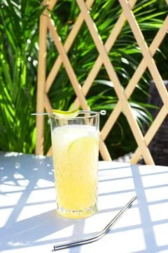 Refreshing melon smoothie with ice and lime in the sun. Summer cooling drinks. Stock Photos