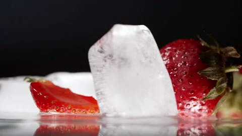 Refreshing melting ice cubes with fresh strawberries Stock Footage 196980907