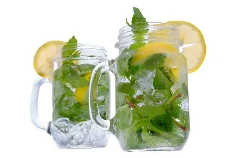 Refreshing mint and lemon drink in glass jars Stock Photos