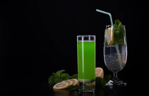 Refreshing mint cocktail on a black background . Stock Photos