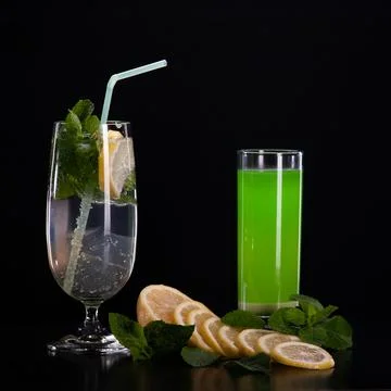 Refreshing mint cocktail on a black background . Stock Photos