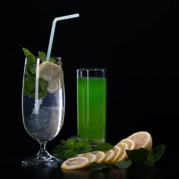 Refreshing mint cocktail on a black background . Stock Photos