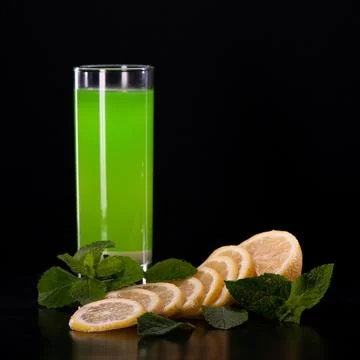 Refreshing mint cocktail on a black background . Stock Photos