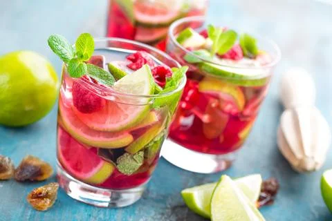 Refreshing mint cocktail mojito with rum, lime and raspberry, cold drink or.. Stock Photos