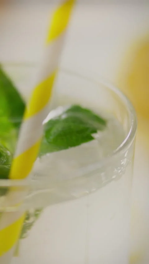 Refreshing mint drink with fresh leaves and lemon slices on a sunny day Stock Footage 331724177