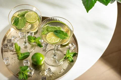 Refreshing mojito cocktails with mint and lime on tray Stock Photos