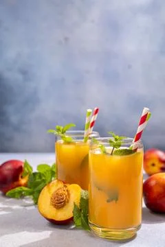 Refreshing nectarine juice with mint and ice ready for drinking Stock Photos