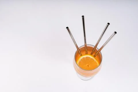 Refreshing orange drink with lemon slice and eco-friendly reusable metal st.. Stock Photos