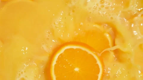 Refreshing orange juice explosion with falling fruit slices Stock Footage 328111051