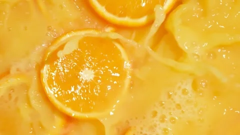 Refreshing orange juice explosion with falling fruit slices Stock Footage 329416804