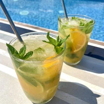 Refreshing Orange Mojito by the Pool Stock Photos