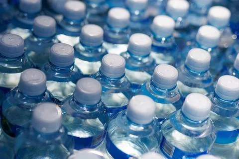Refreshing Pattern of Packed Water Bottles with White Caps. Stock Photos