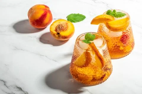 Refreshing Peach Bourbon Smash Cocktail with ice cubes, and mint in glass. .. Stock Photos
