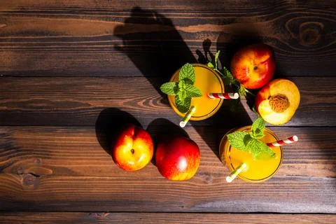 Refreshing peach nectar drinks with mint on wood surface Stock Photos