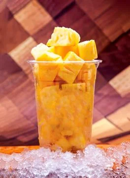 Refreshing Pineapple Chunks Bricks with Crushed Ice served in plastic cup i.. Foto stock