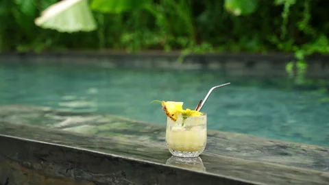 Refreshing pineapple cocktail on poolside bar in tropical resort. Close-up of Stock Footage 271117682