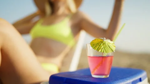 Refreshing pink cocktail with drinking straw and colorful paper umbrella on.. Stock Footage 341342754