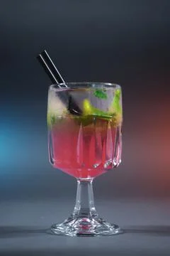 Refreshing pink lemonade with mint or rose cocktail in glass on grey background Stock Photos