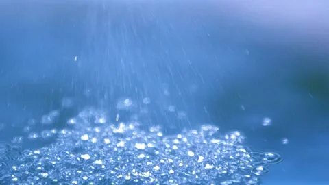 A refreshing rain shower falling on water Stock Footage 138547031