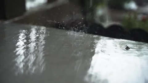 Refreshing Rain Splashing onto a Shiny Surface Video stock 136640152