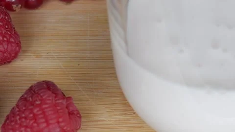 Refreshing Raspberry and Milk Scene for a Vibrant Berry Milkshake Concept Stock Footage 334582648
