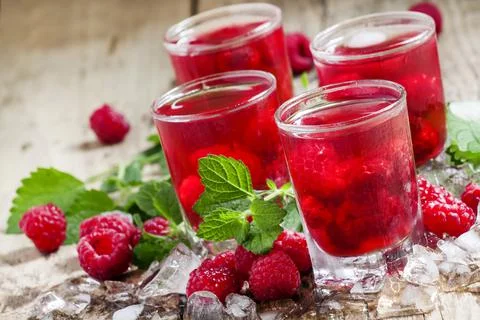 Refreshing raspberry drink with berries, ice and mint, selective focus Stock Photos